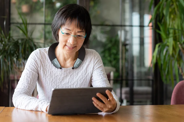 woman wearing the BeHear Proxy - Hearing Amplifier & Wireless Neck Speaker