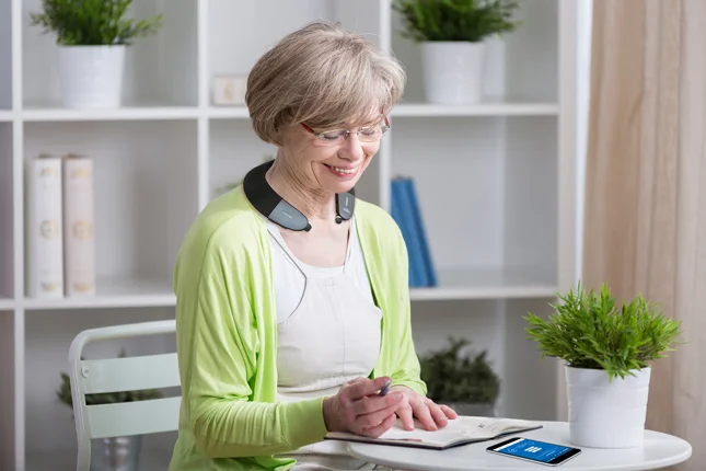 woman wearing the BeHear Proxy - Hearing Amplifier & Wireless Neck Speaker