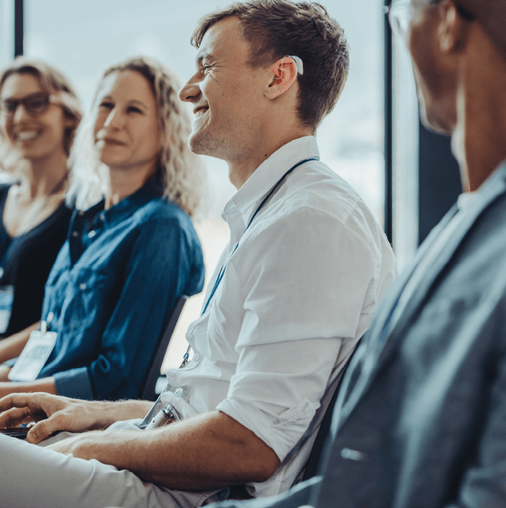 professional at meeting wearing hearing aid